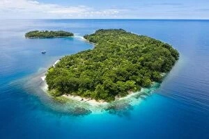 Ireland Collection: A gorgeous, tropical island is surrounded by reef in Papua New Guinea