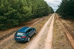 Russia Collection: Lada Vesta Parked On Roadside. Country Road Through Forest