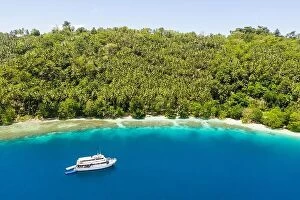 Ireland Collection: A small dive boat is anchored off the coast of Papua New Guinea