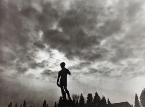 Prints of The copy of David by Michelangelo photographed against the backdrop of a cloudy sky, Piazzale Michelangelo, Florence Florence Piazzale Michelangelo Statue Renaissance-Baroque styles and periods Florence Prints: The copy of David by Michelangelo photographed against the backdrop of a cloudy sky