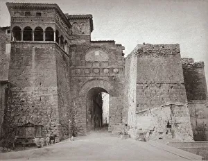 The imposing Arch of Augustus, in Perugia. On the left a few people around a fountain