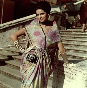 Model posing with a camera