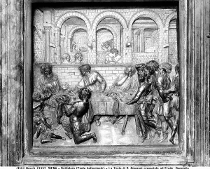 Panel representing the moment when the head of St. John the Baptist is offered to Herod. Sculpted work by Donatello, belonging to the Baptismal Font of the Baptistery of Siena