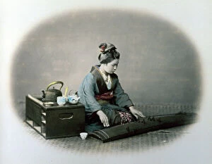 Anthropology Collection: Portrait of a young japanese woman in traditional clothes. The young woman is playing the koto