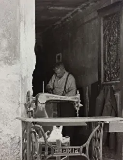 Workshop of a tailor. Singer sewing machine in the foreground