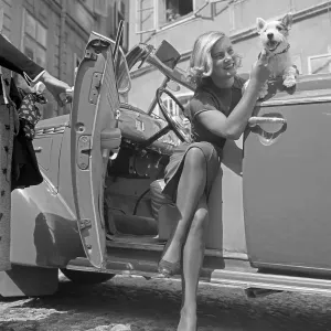 Freizeit Print: Young Woman and Fox Terrier Exiting Convertible, Austria 1930s