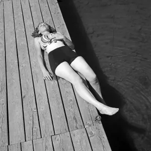 Print of a Young Woman on a Boardwalk by a Lake in Germany, 1930s