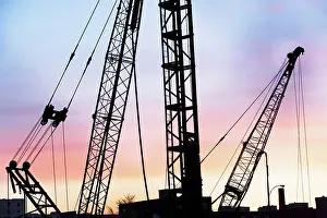 Building Site Equipment Prints: Construction cranes at sunset