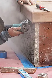 Construction Manpower Prints: Construction worker using grinder at construction site