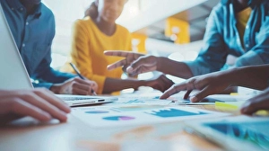 Modern Office Environment Prints: Diverse Team Collaborating Around Laptop Screen with Data Visualization in Modern Office Environment