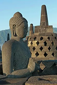 Prints of Indonesia, Java, Borobudur, Seated, granite Buddha with small stupas in the background March Prints: Borobudur Seated Granite Buddha Print