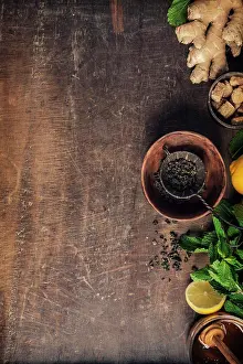 Herbal Tea Ingredients Prints: Tea composition on rustic background: tea, mint, lemon, ginger. Flat lay top view