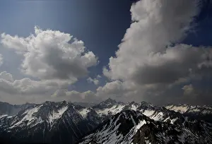 Cloudy Mountain Peaks Prints: Algaeu Alps under a cloudy sky and the peak of Mt
