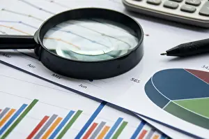 Investment Strategies Prints: Analysis of data, chart and graphs with calculator and magnifying glass