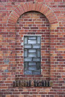 Brick Wall Design Ideas Prints: Arch in a wall made from red bricks with a small glass element