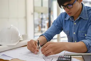 House Building Plans Prints: An architect and engineer carefully using a compass to create house plans