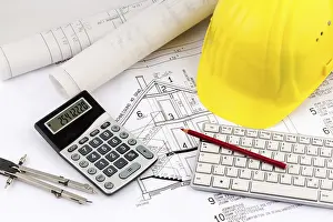 Construction Plan Prints: An architect's construction plan with a builder's helmet