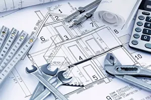 Architect Construction Plan Prints: An architect's construction plan with a calculator
