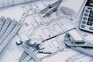 Symbolic House Image Prints: An architect's construction plan with a calculator