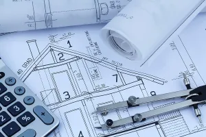Construction Project Planning Prints: An architect's construction plan with a calculator