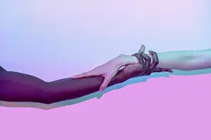 Unity And Diversity Prints: Artistic composition of multiethnic hands touching against a vibrant gradient background