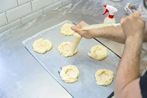 Rustic Bakery Interior Prints: Baker of bakery in the workshop workshop of artisan bakery preparing the buns before baking