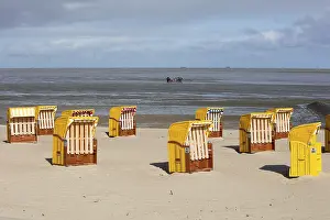 Sandy Ocean Beach Europe Prints: Beach chairs on sandy beach, at back mudflat strollers