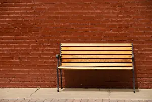 Red Brick Wall Prints: A bench beside a red brick wall