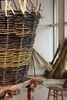 Wicker Basket Prints: Big Wickerwork basket with vegetable material at background