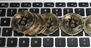 Cryptocurrency Symbol Prints: Bitcoins on Computer Keyboard Background