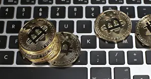 Digital Currency Symbol Prints: Bitcoins on Computer Keyboard Background