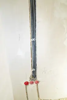 Electrical Wire Management Prints: Black cable ducts inserted into the wall