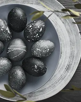 Christian Holiday Traditions Prints: Black painted eggs for Easter on a blue plate