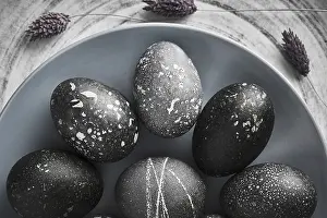 Christian Holiday Traditions Prints: Black painted eggs for Easter on a blue plate