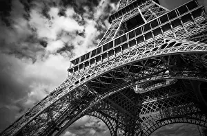 Eiffel Tower Architecture Prints: A black and white view of the Eiffel Tower with dramatic clouds overhead in Paris