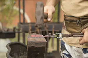 Blacksmith At Work Prints: Blacksmith working on metal on an anvil