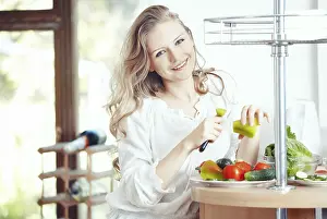 Kitchen Still Life Prints: Blond lady at kitchen preparing vegetable for breakfast