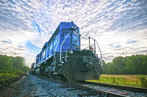 Sunrise Rail Traffic Prints: Blue freight train engine at sunrise