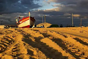 Algarve Beach Prints: Boat on the sand with clouds in sunset