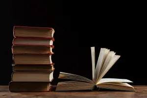 Time Management Calendar Prints: Books stack with dark background