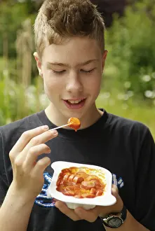 Fast Food Photography Ideas Prints: Boy eats curry sausage