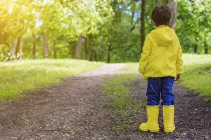 Preschool Child Photography Prints: The boy on the path in the Park stands with his back to the camera