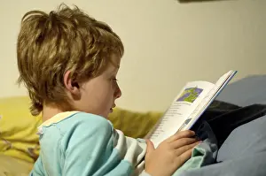 Boy Reading In Bed Prints: Boy reading in bed
