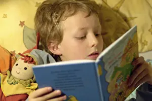 Education For Kids Prints: Boy reading in bed