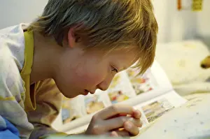Boy Reading In Bed Prints: Boy reading in bed