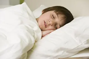 Young Boy In Bed Prints: Boy sleeping in bed