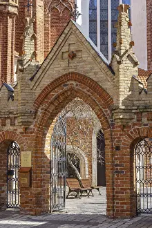 Prints of A brick Gothic gate opens onto a quiet courtyard, Vilnius, Lithuania, Baltic States Related Prints: A Brick Gothic Gate Print, Vilnius, Lithuania