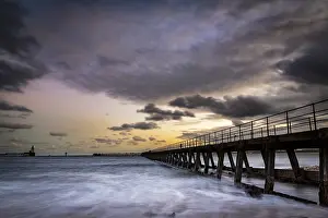 Overcast Sky In Europe Prints: Bridge in the sea with dramatic clouds at sunset