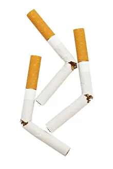 Broken Cigarette Prints: Three broken cigarette on a white background
