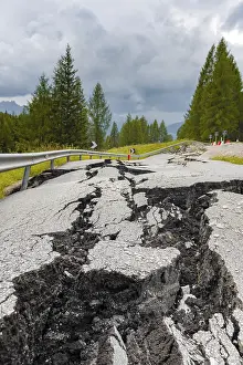 Deserted Mountain Roads Prints: Broken road with cracks in the road surface